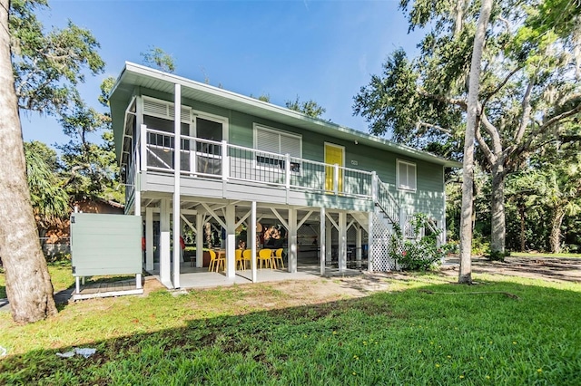 rear view of house featuring a patio, a sunroom, and a yard