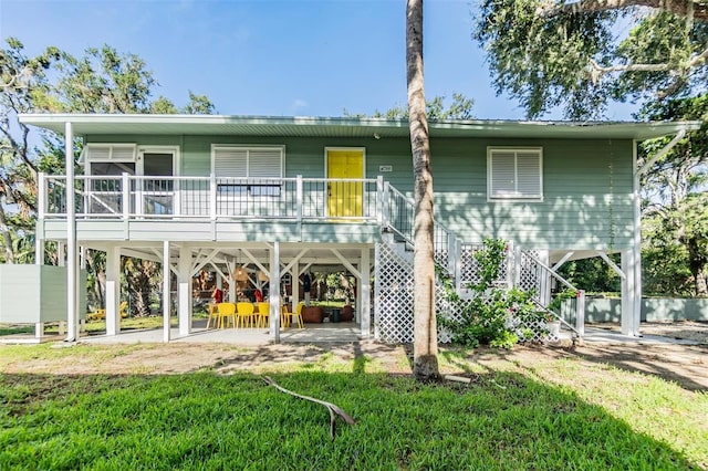 back of property featuring a patio and a yard