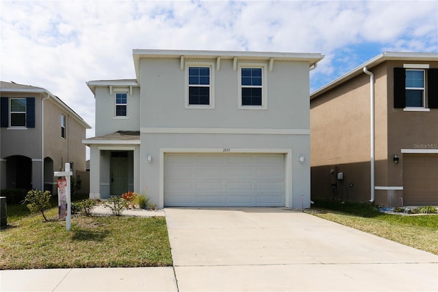 traditional home featuring driveway, an attached garage, and stucco siding