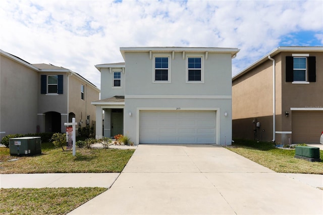 traditional home with driveway, an attached garage, a front yard, and stucco siding