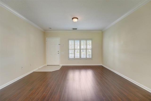 empty room with crown molding and dark hardwood / wood-style flooring