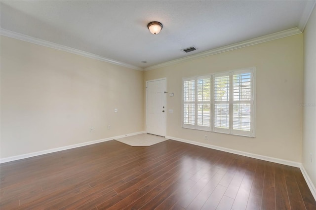 empty room with dark hardwood / wood-style flooring and ornamental molding