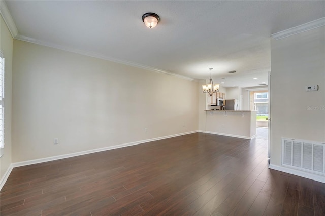 unfurnished living room featuring a chandelier, dark hardwood / wood-style floors, and crown molding