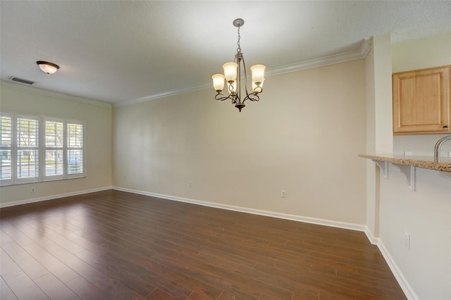 unfurnished dining area featuring crown molding, dark wood-type flooring, and an inviting chandelier