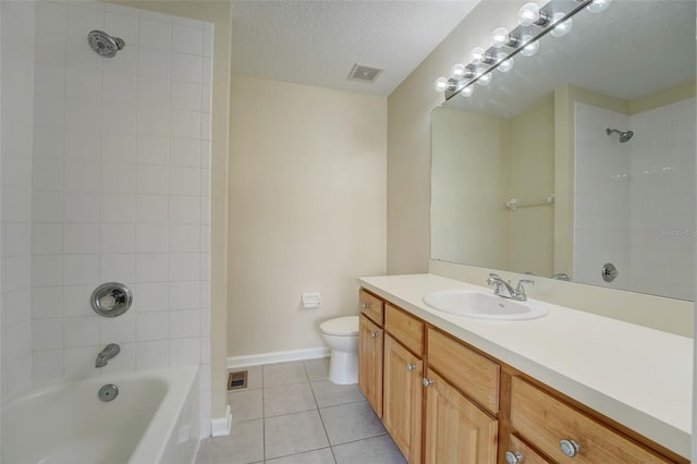 full bathroom featuring tiled shower / bath combo, tile flooring, a textured ceiling, toilet, and large vanity