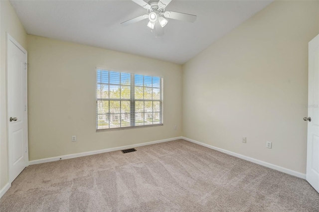 carpeted empty room featuring lofted ceiling and ceiling fan