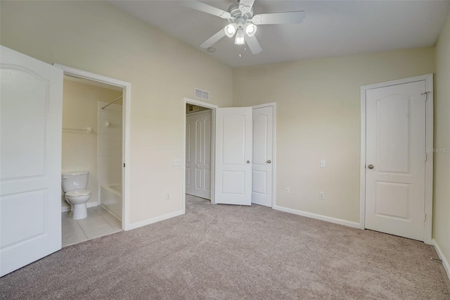 unfurnished bedroom featuring light carpet, connected bathroom, ceiling fan, and lofted ceiling