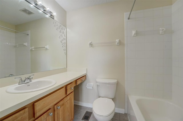 full bathroom with tile floors, tiled shower / bath, a textured ceiling, toilet, and large vanity