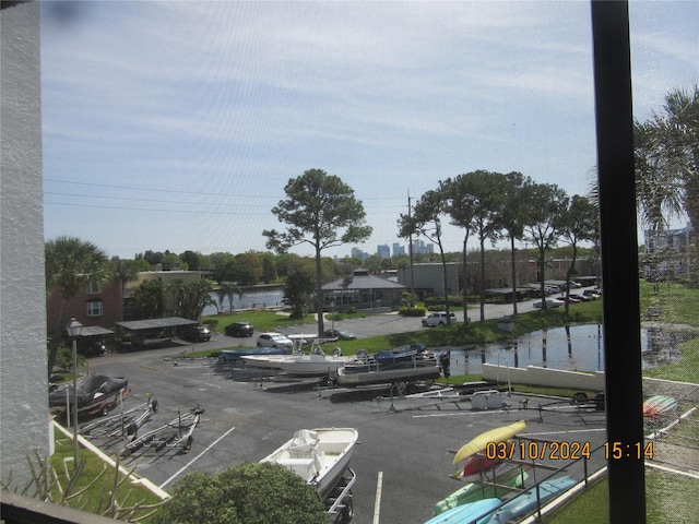 view of vehicle parking featuring a water view