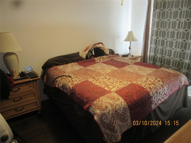 bedroom with dark wood-type flooring