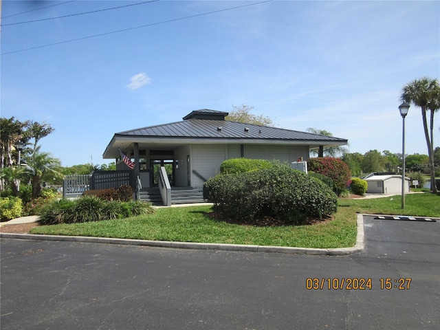 view of front of home with a porch and a front yard