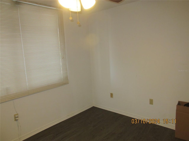 unfurnished room with ceiling fan and dark hardwood / wood-style flooring