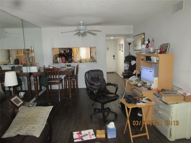 office area with a textured ceiling, ceiling fan, and dark hardwood / wood-style floors