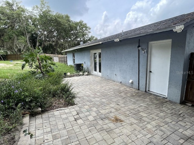 exterior space with central AC unit and french doors