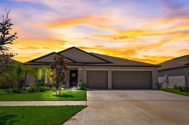 view of front of home featuring a yard and a garage