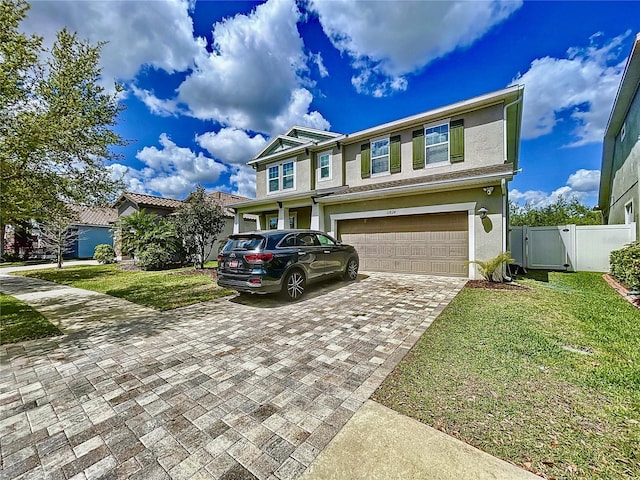 view of front of property with a front yard and a garage