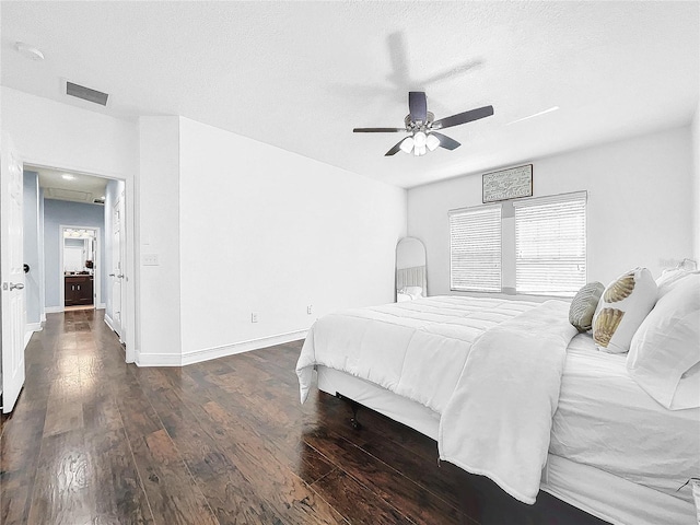 bedroom featuring ceiling fan, a textured ceiling, and dark wood-type flooring