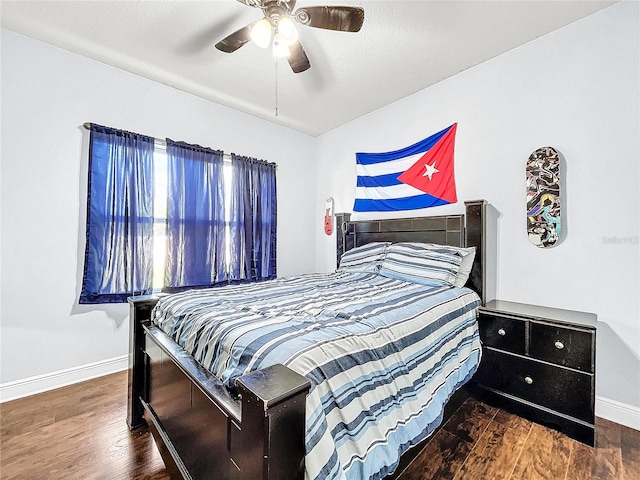 bedroom with ceiling fan and dark wood-type flooring