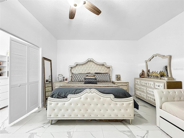 tiled bedroom featuring a closet and ceiling fan