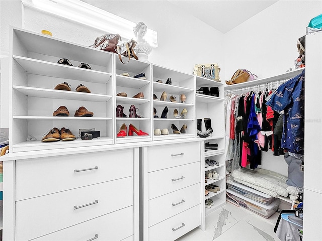 spacious closet with light tile flooring