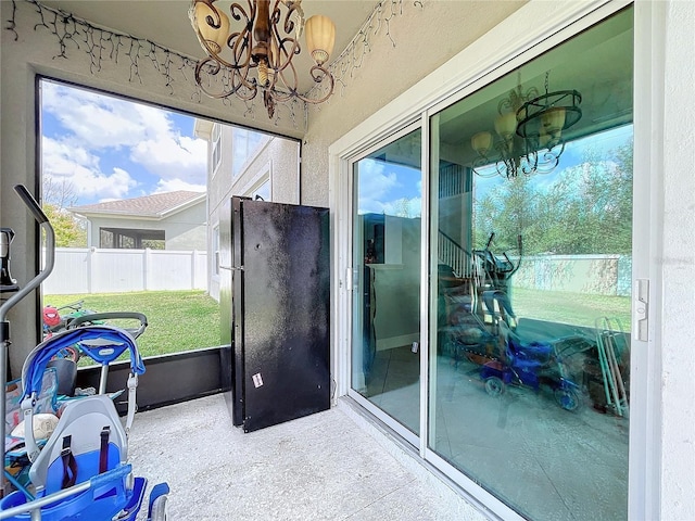 sunroom / solarium featuring a notable chandelier and a wealth of natural light