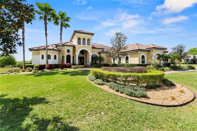 mediterranean / spanish-style house featuring a front lawn