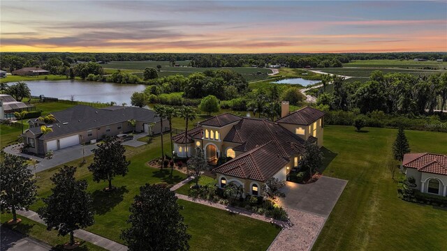 aerial view at dusk with a water view