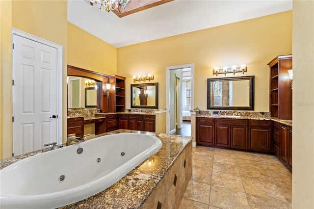 bathroom featuring double vanity, a chandelier, and tile flooring