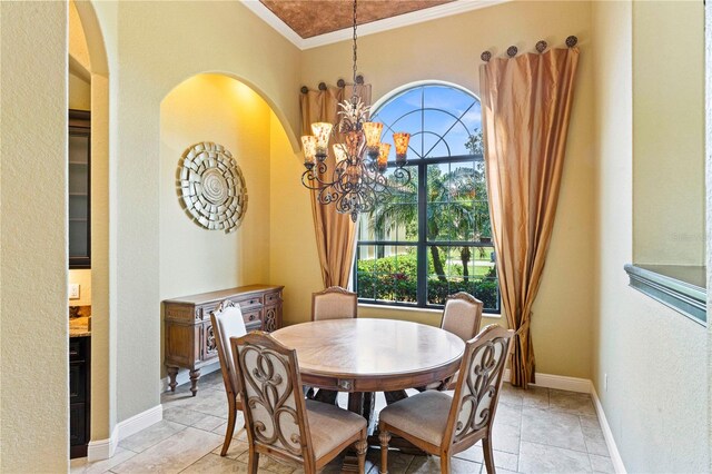 tiled dining space with an inviting chandelier and ornamental molding