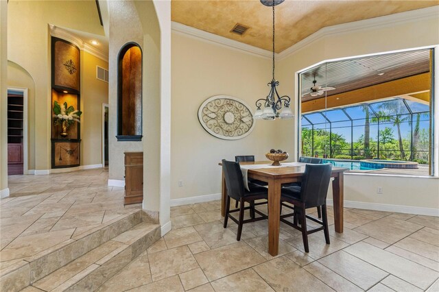 tiled dining space featuring crown molding and ceiling fan with notable chandelier