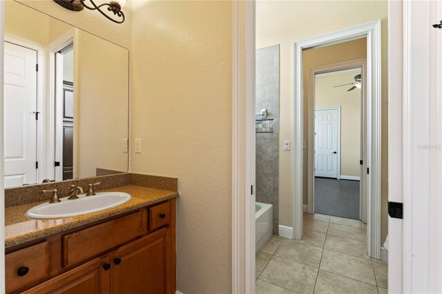 bathroom featuring tile floors, ceiling fan, and vanity