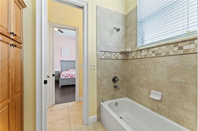 bathroom featuring tiled shower / bath combo, hardwood / wood-style floors, and ceiling fan