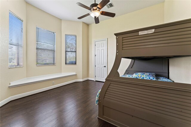 unfurnished bedroom with dark hardwood / wood-style flooring and ceiling fan