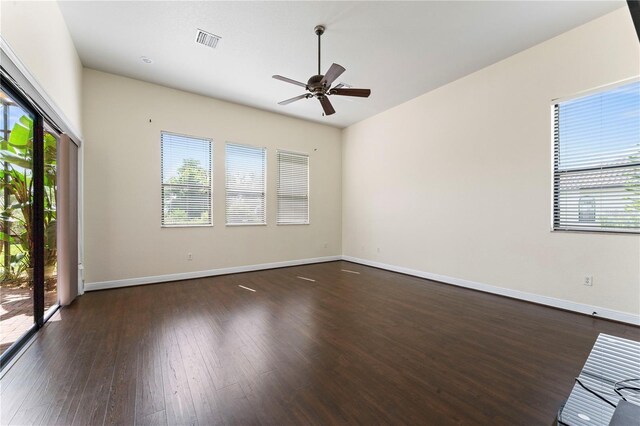 unfurnished room featuring dark wood-type flooring and ceiling fan