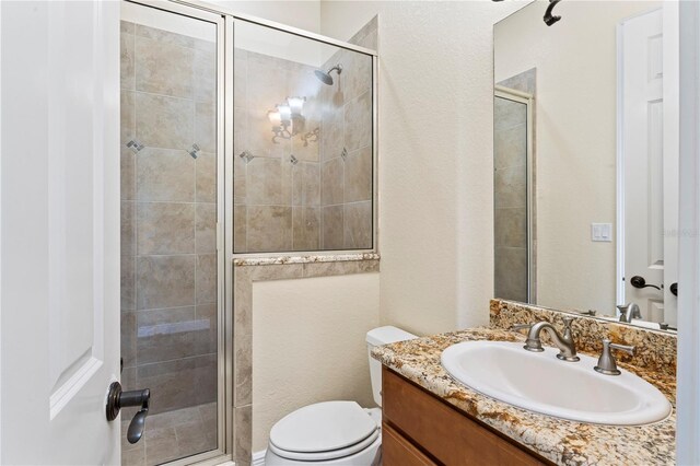 bathroom with toilet, walk in shower, and oversized vanity