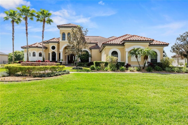 mediterranean / spanish-style home with a front yard