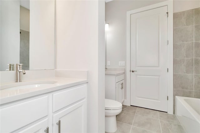 bathroom with tile patterned flooring, vanity, and toilet