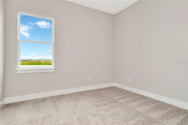 carpeted spare room featuring plenty of natural light