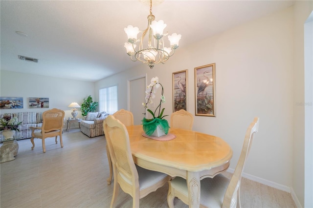 dining space with a notable chandelier