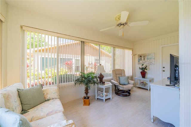 sunroom / solarium featuring ceiling fan