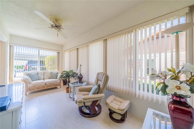 sunroom featuring ceiling fan