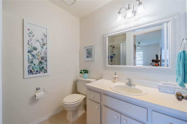 bathroom with toilet, ceiling fan, and vanity