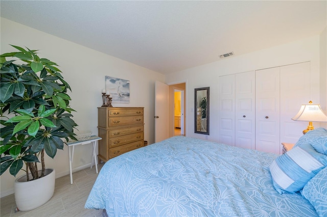 bedroom featuring a closet and light tile flooring