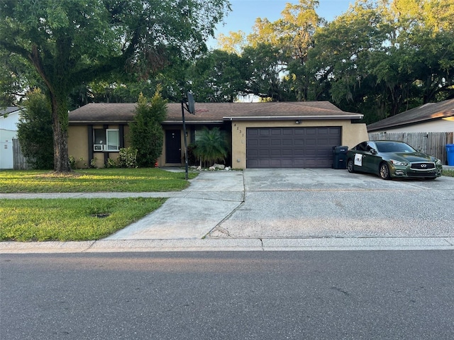 ranch-style home with a front lawn and a garage