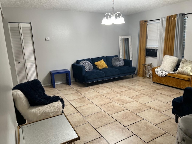 living room featuring an inviting chandelier, a textured ceiling, and light tile floors