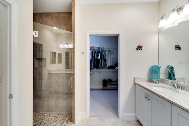 bathroom with an enclosed shower, vanity, and tile floors