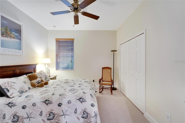 bedroom featuring light carpet, a closet, and ceiling fan