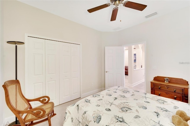 carpeted bedroom with a closet and ceiling fan