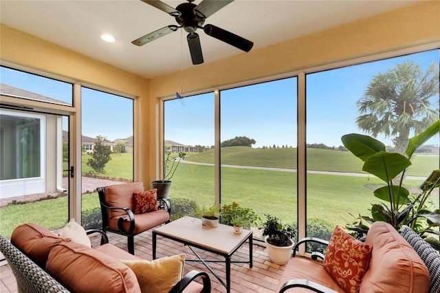 sunroom / solarium featuring ceiling fan