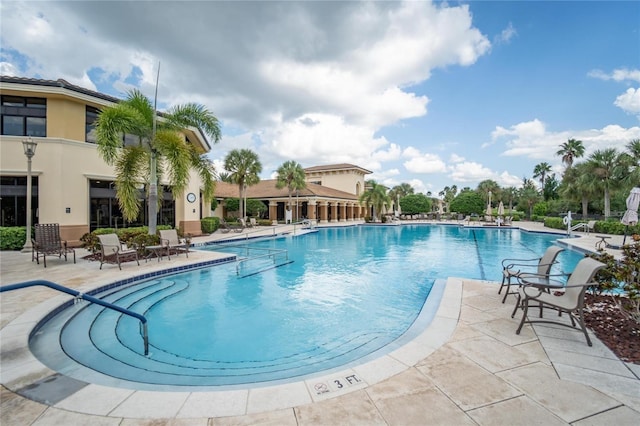 view of swimming pool featuring a patio area